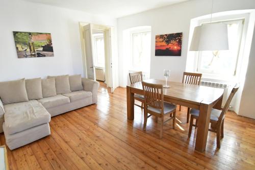 a living room with a table and a couch at Panorama in Aurisina