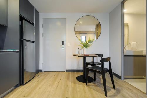 a dining room with a table and a mirror at Amazing Apartments in the Heart of Interlomas in Mexico City
