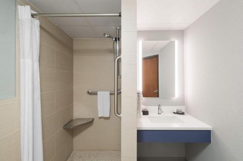 a bathroom with a sink and a shower at AmericInn by Wyndham Tofte Near Lake Superior in Tofte