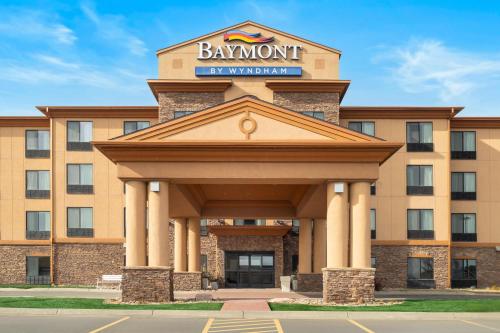 a hotel with a sign on top of a building at Baymont Inn & Suites by Wyndham Sturgis in Sturgis
