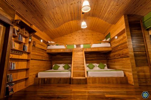 a room with two beds in a wooden room at Hotel Narangala Wooden Villa in Badulla