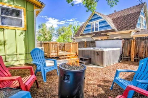 a backyard with rocking chairs and a hot tub at The Vibrant Victorian Hot Tub & Fire Pit in OCC in Colorado Springs