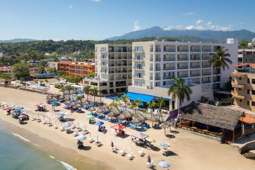 an aerial view of a beach with people sitting on the sand at Decameron La Marina Guayabitos, Ramada All-Inclusive Resort in Rincon de Guayabitos
