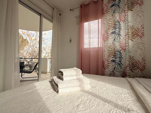 a bedroom with a bed with towels on it at Zinas modern flat Nicosia in Strovolos