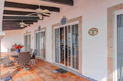 a dining room with a ceiling fan and a table at Ocean Front Villa - Private Pool and Ocean Access in Puerto Vallarta