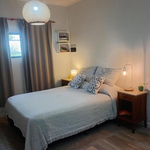 a bedroom with a bed with two pillows on it at LIVe in Villa Elisa