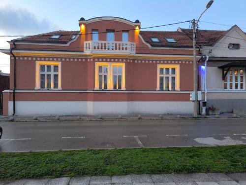 a house on the side of a street at Apartment By the River in Niš
