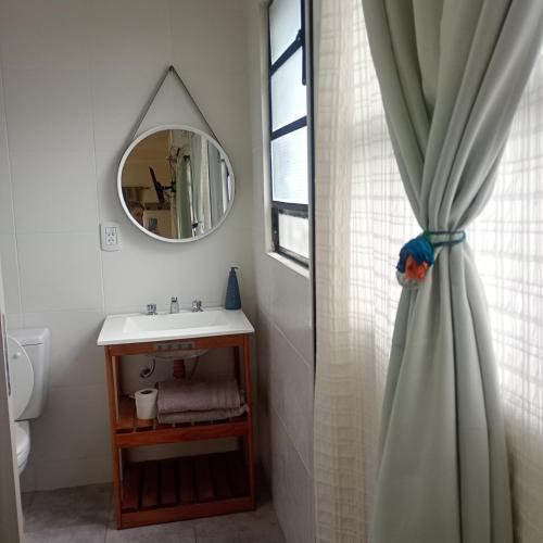 a bathroom with a sink and a shower curtain at LIVe in Villa Elisa
