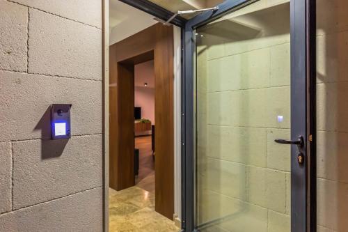 a glass door leading into a hallway with a wall at Luxury Villa MAJA in Baška Voda