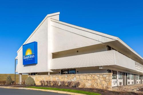 a building with a sign on the side of it at Days Inn by Wyndham Kansas City Northeast in Kansas City