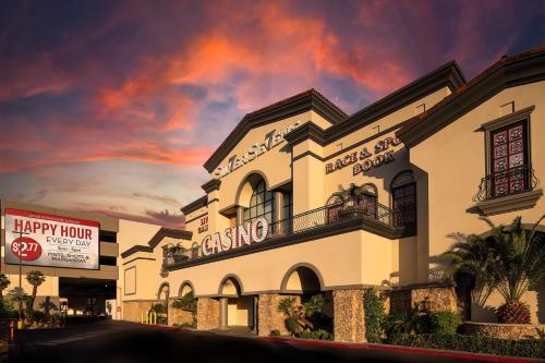 a large white building with a cloudy sky in the background at Silver Sevens Hotel and Casino, a Wyndham Garden in Las Vegas