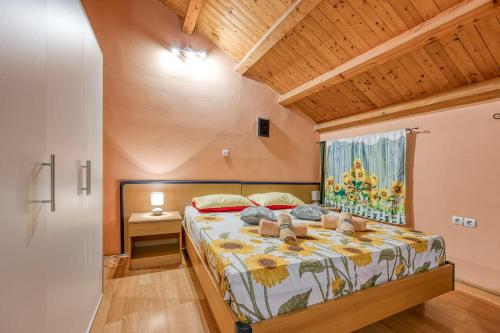 a bedroom with a bed with shoes on it at App Bonić in Veli Lošinj