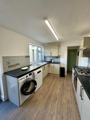 a large kitchen with a washer and dryer in it at The Beach House in Mablethorpe