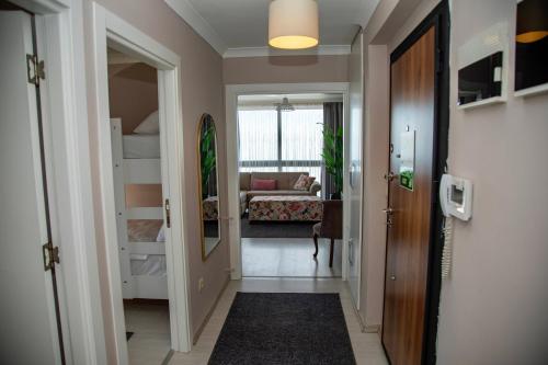 a hallway with a room with a bed and a door at Sofia Beach Residence in Trabzon