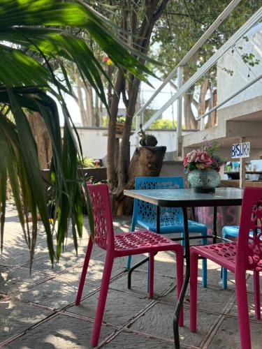 a table and four chairs and a table and a table and chairs at Margaritas Eco Haus in Querétaro