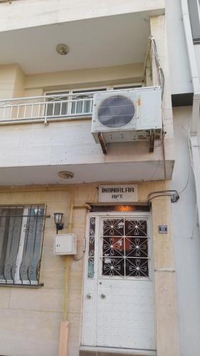 a building with a balcony and a door with a fan at Huzur10 in Edirne