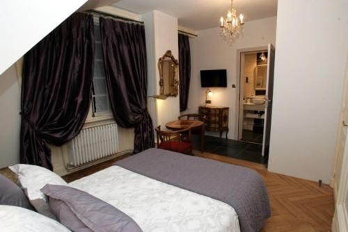 a hotel room with a bed and a window at Le BALCON DU PRINCE in Montbéliard