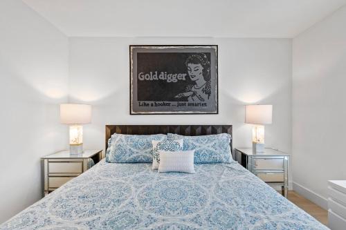 a bedroom with a blue bed with two night stands at 8 Santa Monica Huge Stylish Apartment in Los Angeles