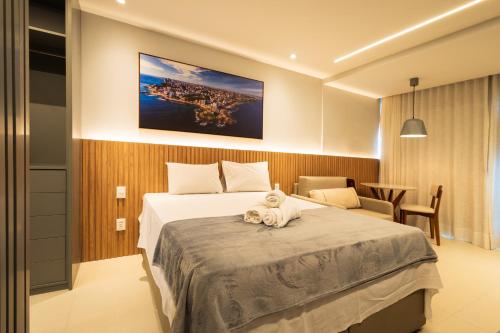 a bedroom with a bed with a teddy bear on it at Art studio open space in Água Boa