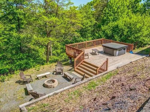 a large wooden deck with chairs and a fire pit at Haven View Retreat in White Haven