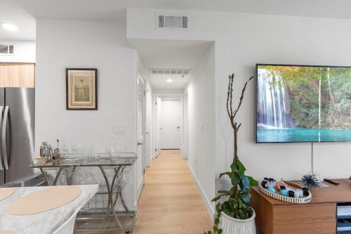 a hallway of a home with a waterfall painting on the wall at 9 Advantages Center Santa Manica in Los Angeles