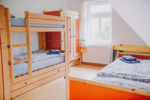 a bedroom with two bunk beds and a window at Friesenpark 10 in Wurster Nordseeküste