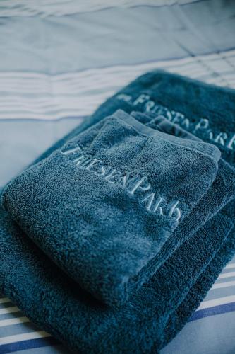 a blue towel sitting on top of a bed at Friesenpark 10 in Wurster Nordseeküste