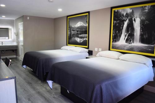 a hotel room with two beds and a sink at Super 8 by Wyndham Visalia in Visalia