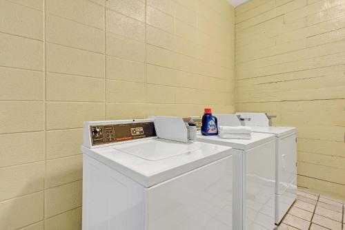 a laundry room with two washing machines in it at Super 8 by Wyndham Indianapolis South in Indianapolis