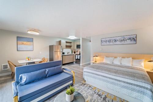 a hotel room with a bed and a couch at Interurban Suites Hotel, a Dazzler Select by Wyndham in Tukwila