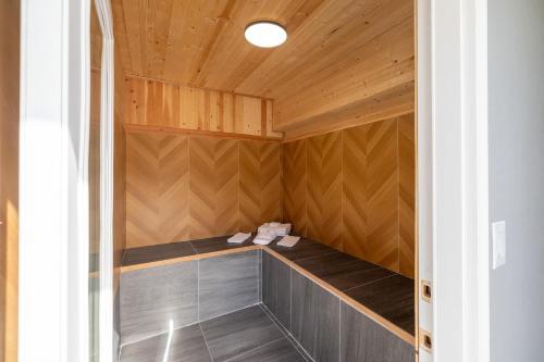 a sauna with wooden walls and a wooden ceiling at Interurban Suites Hotel, a Dazzler Select by Wyndham in Tukwila