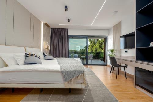 a bedroom with a bed and a living room at Luxury Villa Elements - Novalja in Novalja