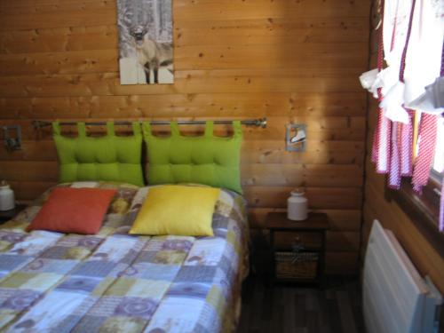 une chambre avec un lit dans une cabane en rondins dans l'établissement Appartement Cosy, à Gérardmer