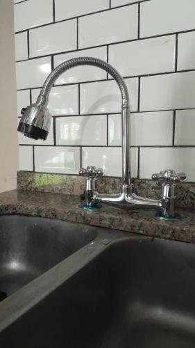 a kitchen sink with a faucet on a counter at Las catalinas in General Rodríguez