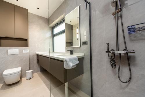 a bathroom with a toilet and a sink and a shower at Luxury Villa Elements - Novalja in Novalja
