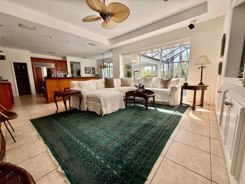 a living room with a couch and a green rug at Tranquil Court Oasis in Sarasota