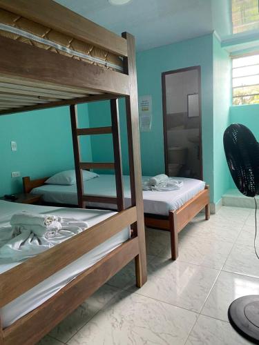two bunk beds in a room with a mirror at Hotel Y Transporte LadyMar in Nuquí