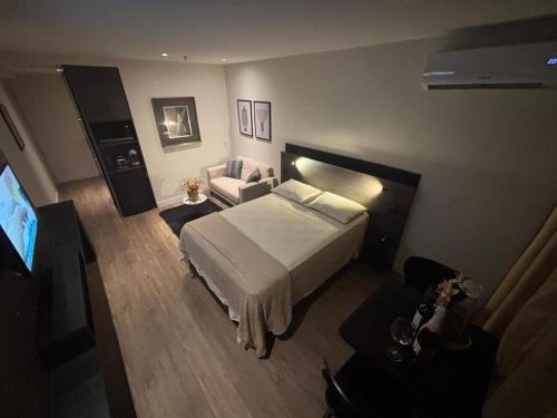 a hotel room with a bed and a couch at América Executive Apart Hotel Campos - LAMAG in Campos dos Goytacazes