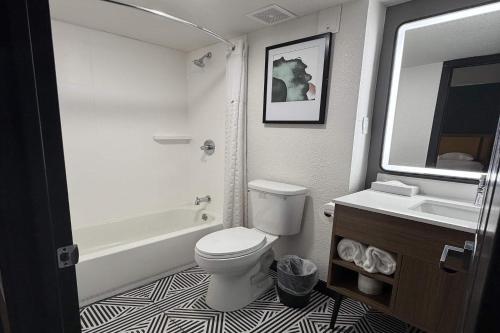 a bathroom with a white toilet and a sink at La Quinta Inn by Wyndham Salt Lake City Midvale in Midvale