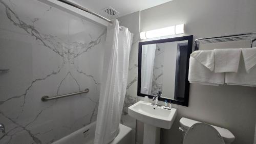 a bathroom with a sink and a toilet and a shower at Roosevelt Inn at Roosevelt Blvd, Philadelphia, PA in Philadelphia