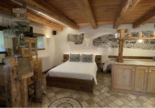 a bedroom with a bed in a room with wooden ceilings at Il Cuore di Sopalù in Candide