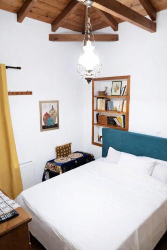 a bedroom with a bed and a table and chairs at Archontiko Kastellia - Stone Guesthouse with Fireplace and Mountain View in Evangelístria