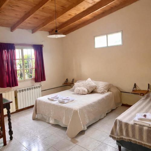 a bedroom with a bed with towels on it at Hostel Buenos Aires in El Calafate