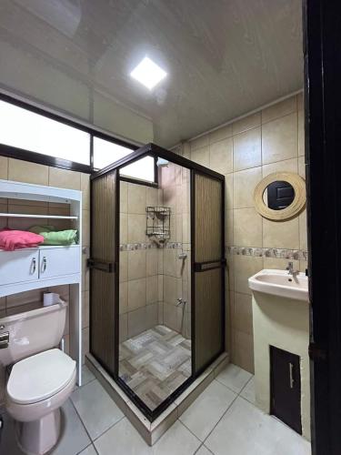 a bathroom with a shower and a toilet and a sink at Casa Roma in Chorro