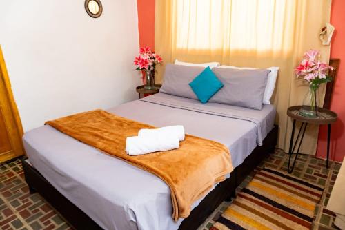 a bedroom with a bed with two towels on it at Hotel Casa Real Villeta in Villeta