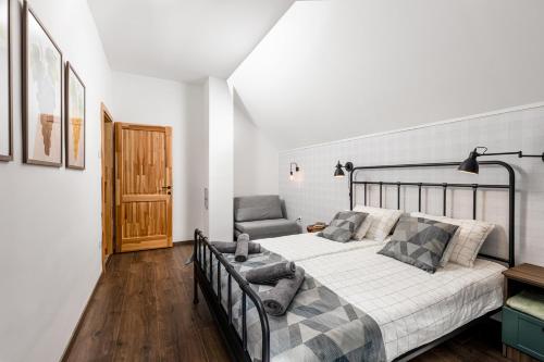 a bedroom with a bed and a chair at Hébér Ház in Románd