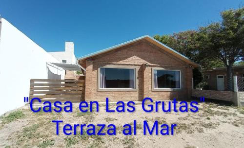 a house on a hill with the words casa an las guinas teraja at Casa en Las Grutas in Las Grutas