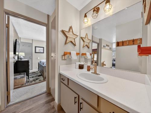 a bathroom with a sink and a mirror at Giant Steps 12 Rustic Retreat ski in out in Brian Head
