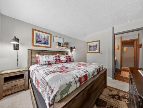 a bedroom with a bed with a wooden frame at Giant Steps 12 Rustic Retreat ski in out in Brian Head