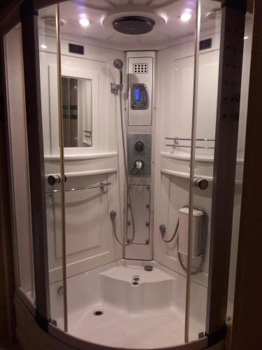 a small bathroom with a shower in a room at Home Apartman in Debrecen